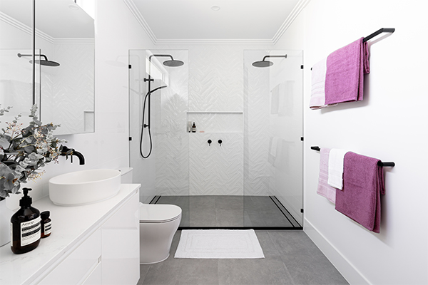 White bathroom with double shower and modern fittings