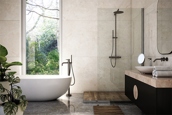 Modern bathroom with beige tiles, freestanding bath and frameless glass shower