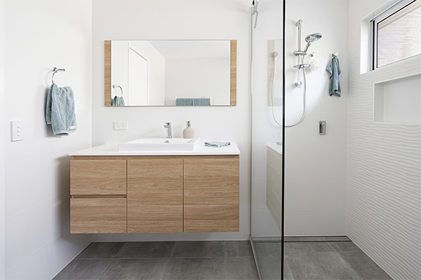 Modern white bathroom with timber cabinetry and stepless tiled white shower with wall nice