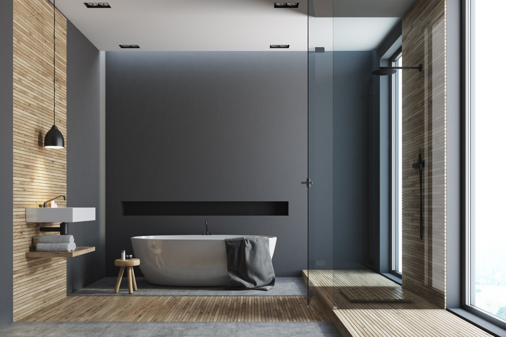 Open plan modern bathroom with timber and dark grey painted walls, freestanding bath and glass shower