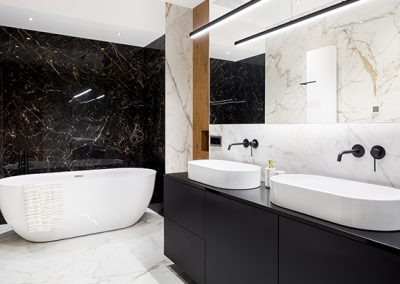 Black and white bathroom with marble look walls